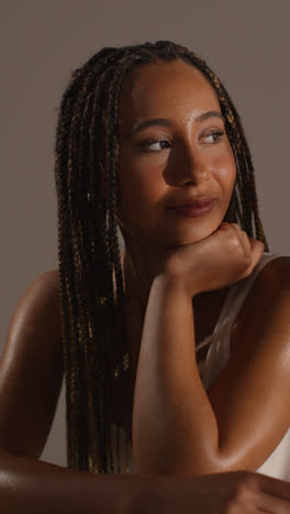 Studio-Beauty-Shot-Of-Smiling-Young-Woman-With-Long-Braided-Hair-Against-Neutral-Background-5